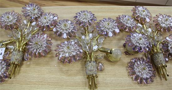 A set of four 20th century amethyst and clear glass five light wall lights designed as sprays of flowers